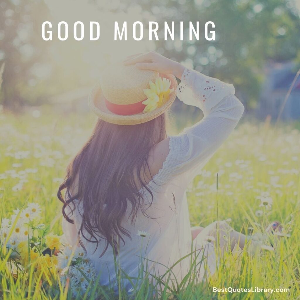 A girl sitting in a garden with some flower holding cap with the yellow flower saying Good Morning