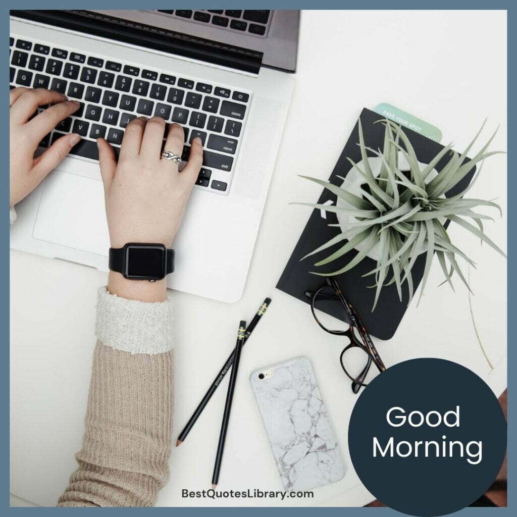 A lady working on laptop wearing ring & Smart watch keeping Pencil mobile specks and diary with flowerpot