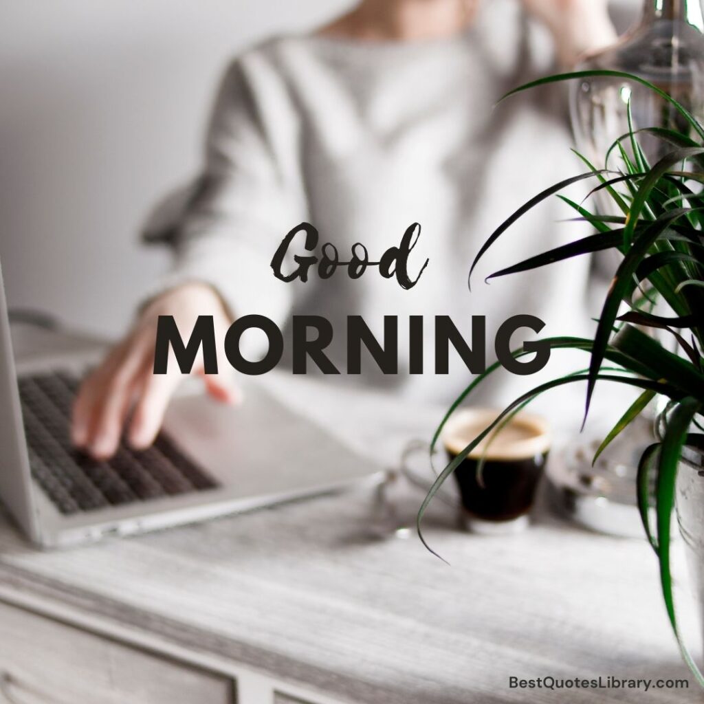 A lady working on laptop with tea in cup