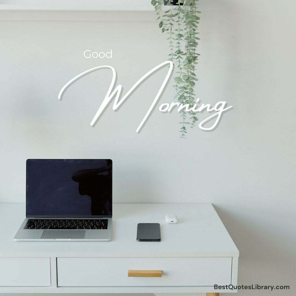 A laptop and mobile on desk with drawer in morning